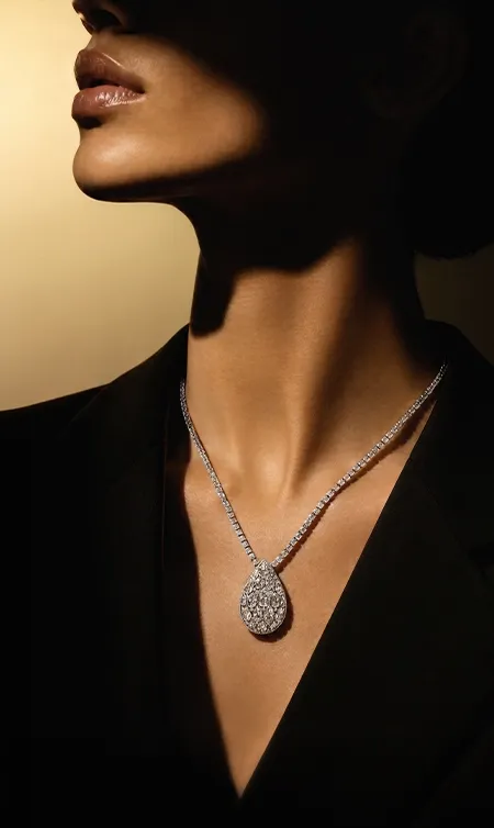 Model wearing Tear Cascade Pendant from the High Jewelry collection. 